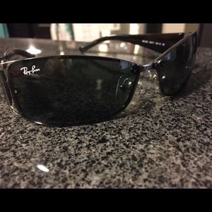 A unisex pair of Ray-Ban sunglasses with the case